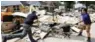  ?? - AP/PTI ?? NATURE’S FURY: Volunteers throw a kitchen sink damaged by floodwater­s onto a pile of debris in the aftermath of Hurricane Harvey on Sunday, in Spring, Texas.