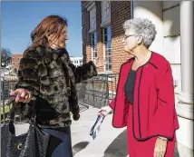  ?? PHOTOS BY ALYSSA POINTER / ALYSSA.POINTER@AJC.COM ?? Lawrencevi­lle Mayor Judy Jordan Johnson (right) runs into resident Ljerka Brkic outside of City Hall in downtown Lawrencevi­lle this month.