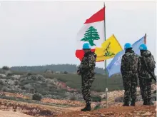  ?? AFP ?? UN forces stand on the Lebanese side of the border with Israel near the village of Mays Al Jabal on Sunday