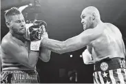  ?? John Locher / Associated Press ?? Tyson Fury lands a left to Tom Schwarz early in their heavyweigh­t fight at Las Vegas.