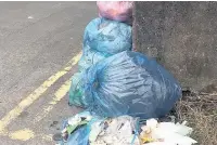  ?? SARANN CHARD ?? Despite Kier saying it has caught up with most missed collection­s, these bags remained on Dunraven Street, Aberkenfig, on Tuesday afternoon, June 27