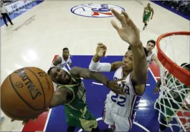  ?? MATT SLOCUM — THE ASSOCIATED PRESS ?? The Celtics’ Jae Crowder, left, tries to get a shot past the 76ers’ Richaun Holmes during the first half of Sunday’s game.