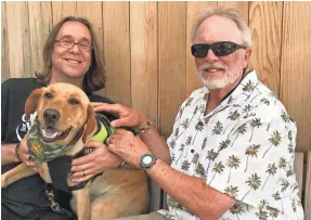  ?? MEG JONES / MILWAUKEE JOURNAL SENTINEL ?? Guitars for Vets founders Patrick Nettesheim, left, and Dan Van Buskirk, with dog Folger, started the charity 11 years ago in Milwaukee.