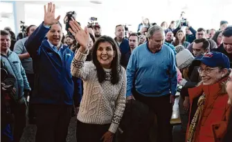  ?? Matt Rourke/Associated Press ?? GOP presidenti­al candidate and former U.N. Ambassador Nikki Haley, center, accompanie­d by New Hampshire Gov. Chris Sununu, left, visits a diner on Sunday in Epping, N.H.