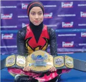  ??  ?? The hijab-wearing, diminutive Malaysian wrestler known as “Phoenix”.