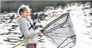  ??  ?? Success . . . Ada Silva (9) prepares to haul in a rainbow trout during the annual Otago Fish & Game Take a Kid Fishing Day at Dunedin’s Southern Reservoir on Saturday.