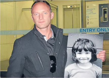  ?? Photo: RICHARD DAVISON/FAIRFAX NZ ?? Oamaru’s Tristan Marris stands outside Dunedin District Court with a picture of his deceased 5-year-old daughter, Ruby.