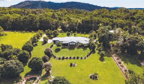  ?? ?? This beautiful four bedroom home at 6B Jarawee Rd, Kuranda, is on a manicured 1.82 acre block.