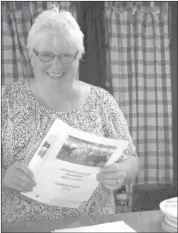  ??  ?? Maureen Murphy, getting the paperwork done. "Now I know what I'm doing," she says, scurrying from one stack of papers to another." Last year, my first, was a crash course on the paperwork side of a county fair. There's lots more to it than most people realize!"