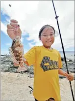  ?? MAUI HUI MALAMA photo ?? A participan­t in Maui Hui Malama’s summer fishing camp program shows off a recently caught fish.