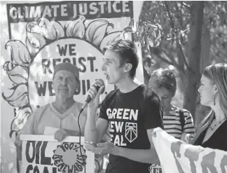  ?? Andy Cross, The Denver Post ?? Youth climate change activist Nick Tuta, center, expresses his concerns during a rally outside of the Margaret Carpenter Recreation Center ahead of the Colorado Oil and Gas Conservati­on Commission’s monthly meeting Wednesday.