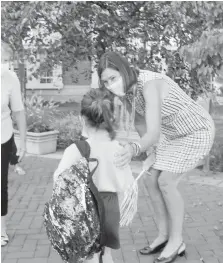  ?? Justin Papp/Hearst Connecticu­t Media ?? Sacred Heart Greenwich Head of School Margaret Frazier greets students on opening day, Sept. 8, 2020.