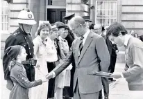  ?? ?? Royal confidant: Brandreth with Prince Philip at a National Playing Fields Associatio­n ceremony in 1987, left; the Prince of Wales, as president of Fields in Trust, helps schoolchil­dren plant poppy seeds, bottom; Brandreth with Mabel the ‘chug’ on Barn Elms playing fields in Barnes, main