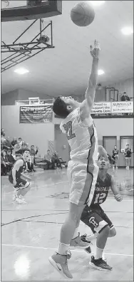  ?? Westside Eagle Observer/RANDY MOLL ?? Gravette’s Johnny Dunfee shoots for two under the basket during Gravette’s game against Huntsville on Friday in Lion Fieldhouse.