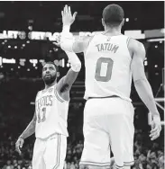  ?? Maddie Meyer / Getty Images ?? Kyrie Irving, left, and Jayson Tatum scored 24 and 22 points, respective­ly, as Boston routed Atlanta.