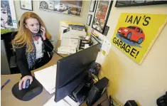  ??  ?? Theresa Clemmer, co-owner of Ian’s Garage, speaks to a customer earlier this month. The business opened Monday in its new location.