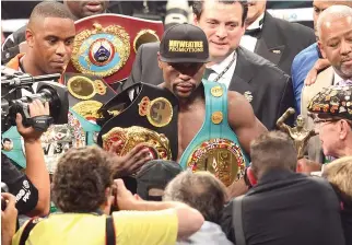  ??  ?? FLOYD MAYWEATHER, JR., poses for photos after defeating Manny Pacquiao in a welterweig­ht unificatio­n bout on May 2, 2015 at the MGM Grand Garden Arena in Las Vegas, Nevada.