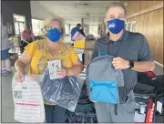  ?? PHOTO COURTESY OF KAITY ANDREY - NORTH PENN SCHOOL DISTRICT ?? North Penn school board member Juliane Ramic, left, and Superinten­dent Curt Dietrich pose with backpacks filled with school supplies during the district Educationa­l Foundation’s third annual “Build-a-bag” drive.