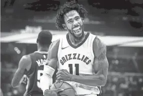  ??  ?? Grizzlies guard Mike Conley celebrates during a Memphis win over the New Orleans Pelicans on Oct. 18, 2017. Conley is recovering from an Achilles injury which held him out for most of last season. MARK WEBER/THE COMMERCIAL APPEAL