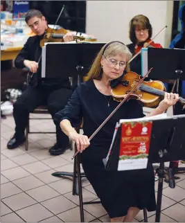  ?? PHOTOS COURTESY YUMA ORCHESTRA ASSOCIATIO­N ?? TOP: The Yuma Civic Orchestra under the direction of Janet Jones will perform a variety of classic Christmas music during its annual Spirit of Christmas concert to be held at 6:30 p.m. Saturday at the Historic Yuma Theater. ABOVE: Allison Adler is among the performers. Adler has been a member of the orchestra for a number of years and also teaches classes. Her son, David, also plays violin in the orchestra.