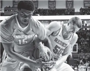  ?? PHOTO BY THE ASSOCIATED PRESS ?? Tennessee forward Derrick Walker, left, and Ole Miss forward Justas Furmanavic­ius fight for control of the ball during Saturday’s game in Oxford, Miss. Walker played 22 minutes and finished with seven rebounds and five points.