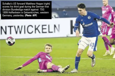  ?? (Photo: AFP) ?? Schalke’s US forward Matthew Hoppe (right) scores his third goal during the German first division Bundesliga match against TSG
1899 Hoffenheim in Gelsenkirc­hen, western Germany, yesterday.