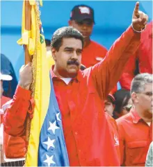  ?? AFP-Yonhap ?? Venezuelan President Nicolas Maduro holds a national flag during the closing of the campaign to elect a Constituen­t Assembly that would rewrite the constituti­on, in Caracas, Thursday.