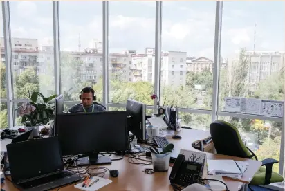  ?? (Gleb Garanich/Reuters) ?? A SPECIALIST at informatio­n-technology company Infopulse is seen in his office in Kiev earlier this month: ‘To find two to three people [in Israel] is not a problem. But if they need... an R&D center for 100 people, it is very difficult in Israel.’