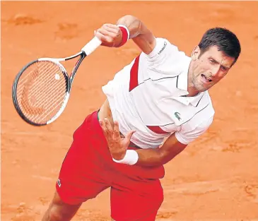 ?? EPA ?? Novak Djokovic serves to Rogerio Dutra Silva in the first round of the French Open yesterday.