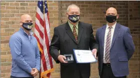  ?? PHOTO COURTESY OF TROY SCHOOL DISTRICT ?? Gary Hauff, Troy Board of Education secretary, (center) was presented with the President’s Award by Troy Superinten­dent Rich Machesky and Don Wotruba, president of the Michigan Associatio­n of School Boards.