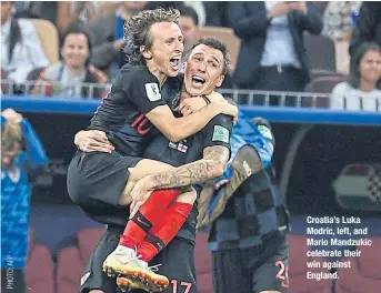  ??  ?? Croatia’s Luka Modric, left, and Mario Mandzukic celebrate their win against England.