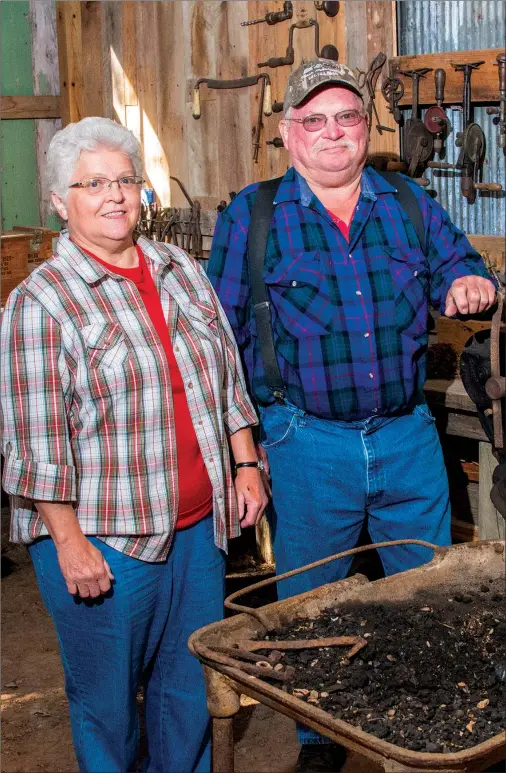  ?? WILLIAM HARVEY/THREE RIVERS EDITION ?? Sue Griffith and her brother, Gary Griffith, stand in the blacksmith shop on the Jackson Creek Homestead “out in the boonies” near Pearson. The two built the pioneer village as a way to honor their parents and display family antiques.