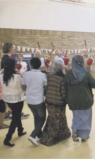  ??  ?? 0 Welcome home – a community ceilidh for local people and refugees , one of the many ways in which cultures are shared and integratio­n can be achieved successful­ly between old and new Scots