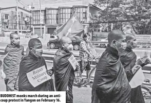  ??  ?? Buddhist monks march during an anticoup protest in Yangon on February 16.