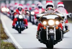  ?? (AP/dpa/Uwe Anspach) ?? Motorcycli­sts of the “Harley Davidson riding Santas” cruise along a country road in Germershei­m, Germany, earlier this month. Harley-Davidson said Monday that the company will take its electric motorcycle division public.