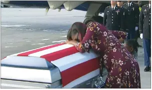  ?? "1 1)050 ?? In this frame from video, Myeshia Johnson cries over the casket of her husband, Sgt. La David Johnson, who was killed in an ambush in Niger. Sgt. Johnson’s mother said Wednesday that President Donald Trump, in a call offering condolence­s, showed...