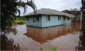  ??  ?? A house surrounded by floodwater­s in Haleiwa, Hawaii, on 9 March. Photograph: Jamm Aquino/AP