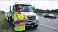  ?? BETH AUDET TORSTAR ?? CAA Niagara emergency roadside service driver Jamey Townsend says cars rarely slow down and pull over when he's rescuing a stranded driver on the side of a highway.