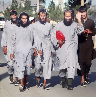  ?? AP ?? Afghan Taliban prisoners after being freed from Bagram prison by the Afghan government in Kabul on Tuesday.