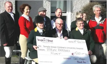  ??  ?? Members of Bray Harriers present a cheque to Bob Hawkshaw (front, middle) of Temple Street Hospital.