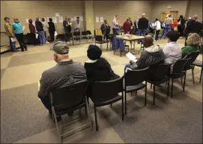  ?? Arkansas Democrat-Gazette/STATON BREIDENTHA­L ?? People wait in line Monday during early voting at the Main Branch of the William F. Laman Public Library in North Little Rock.