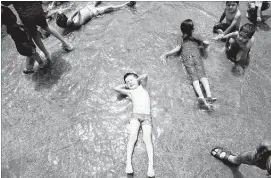  ?? ABEDIN TAHERKENAR­EH/EPA ?? Children cool off Friday at the Cheshme-Ali pool in Shahre-Ray, Iran. Skyrocketi­ng air temperatur­es and humidity levels have pushed heat index values in the Middle East off the charts.