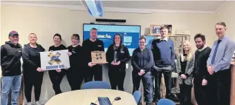  ?? Photograph: MacLeod Constructi­on Ltd. ?? The MacLeod team with their prize, pictured with Midton staff .