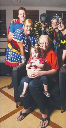  ?? HEROES WELCOME: Tamara McDonald with daughter Kaitlyn and super heroes ( rear from left) Monica Hains, Chris Hains, Joel Day, Michelle Diehm and Linda Owen. ??