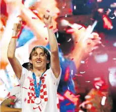  ?? DARKO VOJINOVIC/THE ASSOCIATED PRESS ?? Croatia’s Luka Modric celebrates upon arrival in Zagreb, Croatia on Monday. Tiny Croatia’s progress to the World Cup final against France was one of the compelling stories that attracted a massive TV audience to the FIFA World Cup.