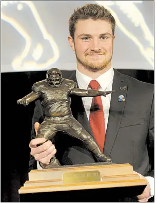  ?? NWA Democrat-Gazette/DAVID GOTTSCHALK ?? Luke Falk, quarterbac­k for Washington State University, received the 2017 Burlsworth Trophy on Monday at the Northwest Arkansas Convention Center in Springdale. The award is named after Brandon Burlsworth, a former walk-on for the Arkansas Razorbacks.