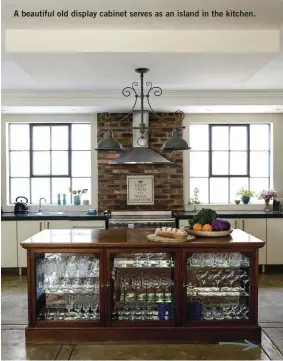  ??  ?? A beautiful old display cabinet serves as an island in the kitchen.