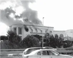  ??  ?? Smoke rises from the site of the headquarte­rs of Libya's foreign ministry after suicide attackers hit in Tripoli, Libya December 25, 2018. (Reuters/Hani Amara)