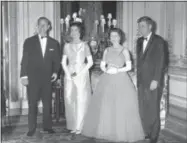  ??  ?? In this June 5, 1961file photo, Queen Elizabeth II poses with U.S. President John F. Kennedy, before a state dinner at Buckingham Palace. At left is the Duke of Edinburgh and Kennedy’s wife, Jackie, is at second left.