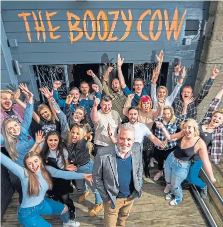  ??  ?? The bar staff at Boozy Cow when it first opened with philanthro­pist and entreprene­ur Garreth Wood.